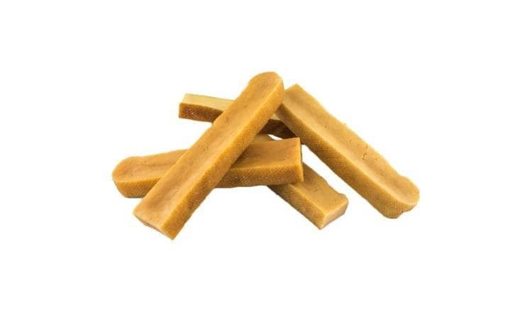 A pile of breadsticks on a white background.
