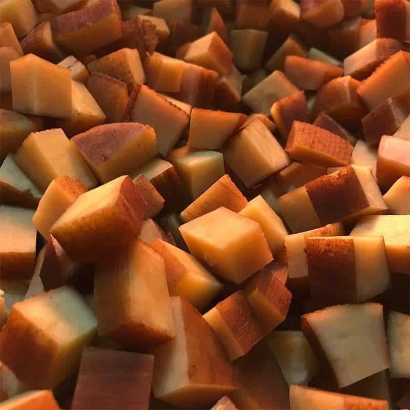 A pile of Churpi Nuggets, a type of dog treat, on a green background. This image is present on the 'Home' page.